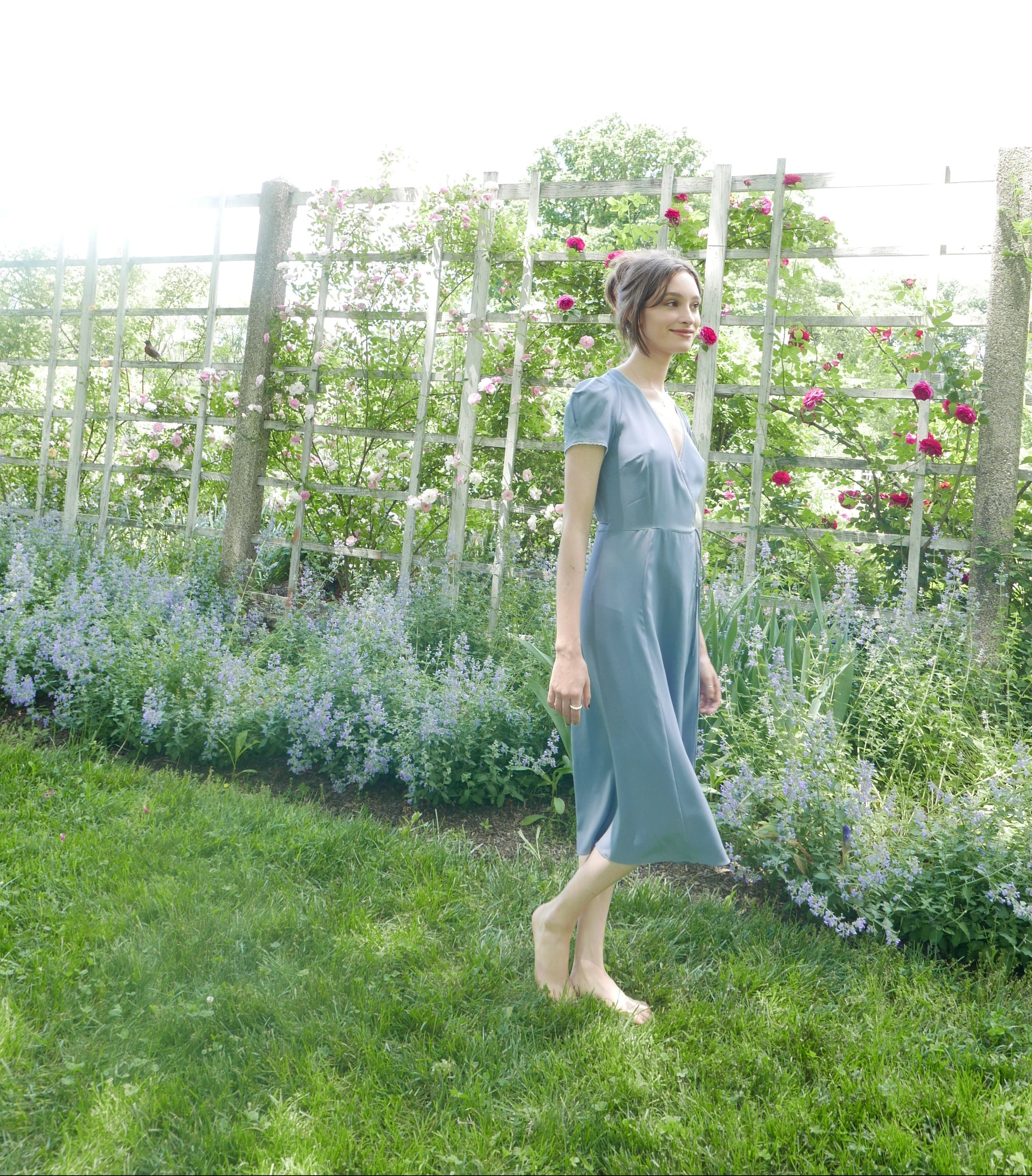 Side view of lavender blue silk wrap dress with waist tie.